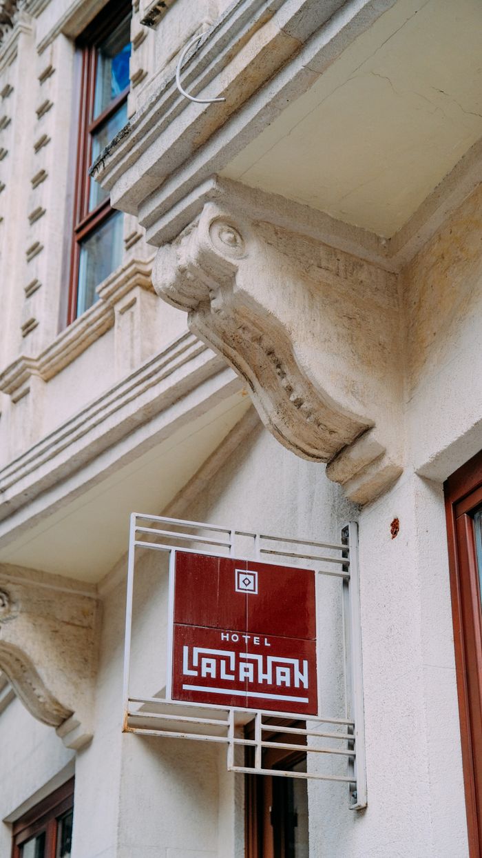 Vintage-style hotel facade featuring ornate architectural details and classic signage.