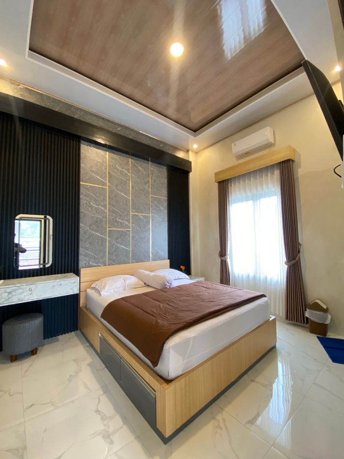 Stylish modern bedroom featuring a cozy bed, chic decor, and natural lighting.